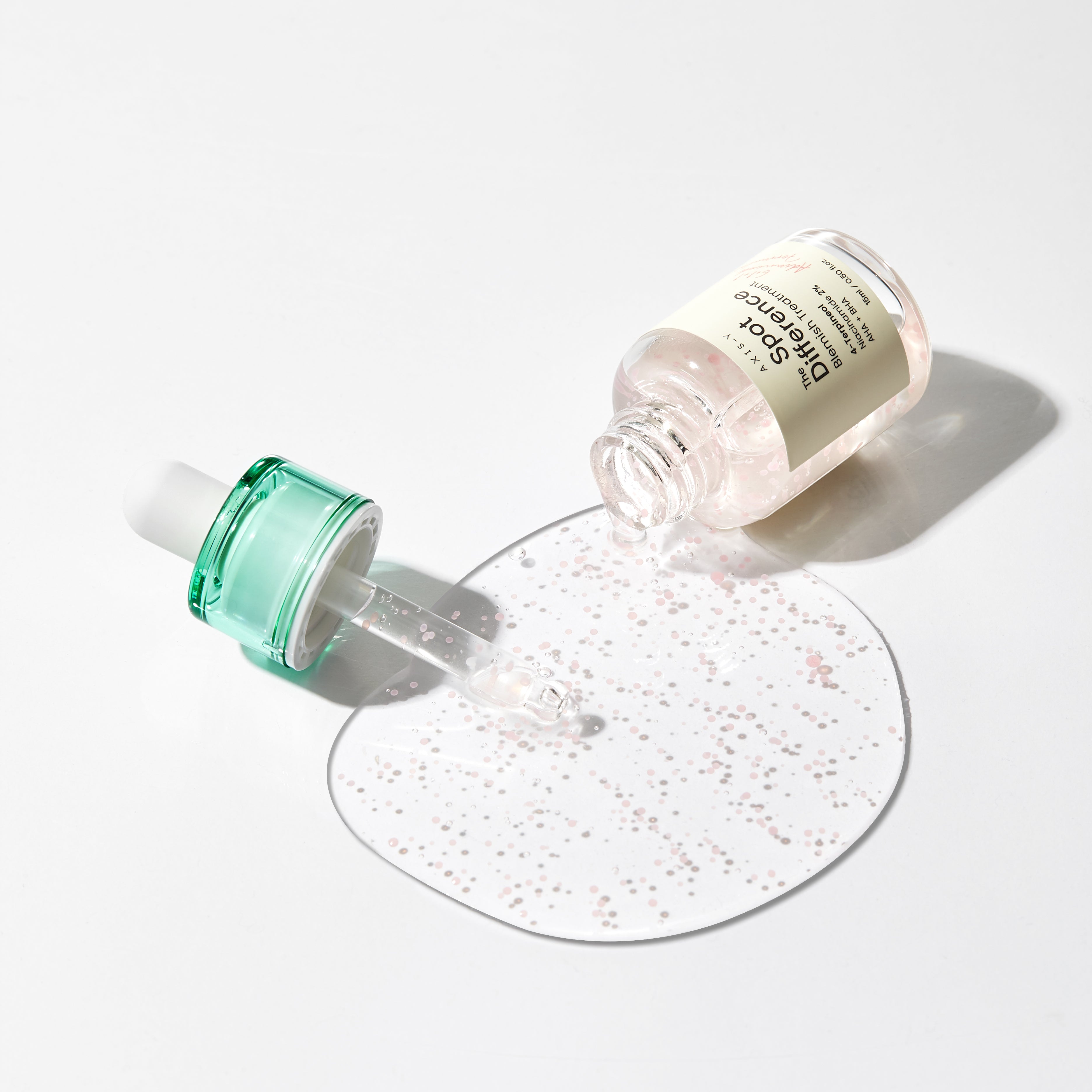 AXIS-Y Spot The Difference Blemish Behandlung Serum in 15ml Flasche, sichtbares Produktfoto mit Verpackung und Applikator
