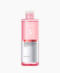 Anua Niacinamide & Tranexamic Acid Brightening Booster Toner in 250 ml Flasche, hellgelbe Flüssigkeit im Pumpflakon.